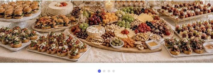 A grazing table with cheeses, fruit, sliders and canapés.